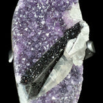 Close Up of an Amethyst Geode with Hematite Crystals and Calcite