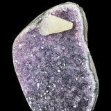 Dogtooth Calcite crystal on purple Amethyst crystals