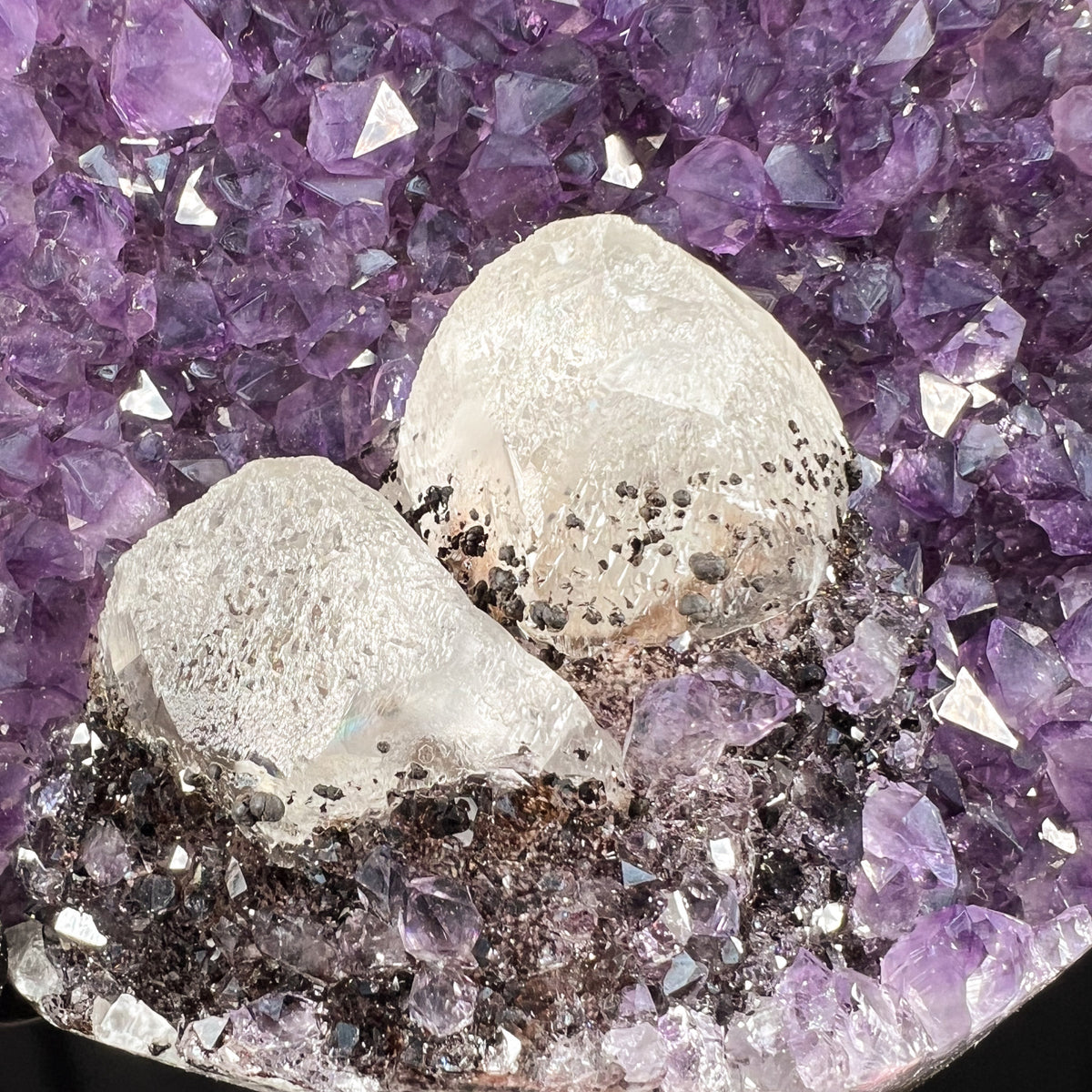 Close Up of Hematite Crystals Coating Calcite inside Amethyst Geode