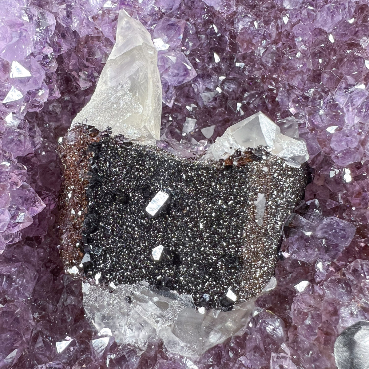 Close Up of Hematite Crystals on Calcite Crystals with Amethyst