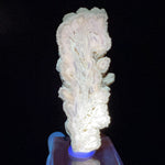 Barite crystal slice displaying fluorescence under UV flashlight