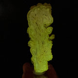 Barite crystal slice displaying phosphorescence under UV flashlight exposure