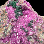 Close-up of pink Cobalto Calcite crystals with green Malachite crystals
