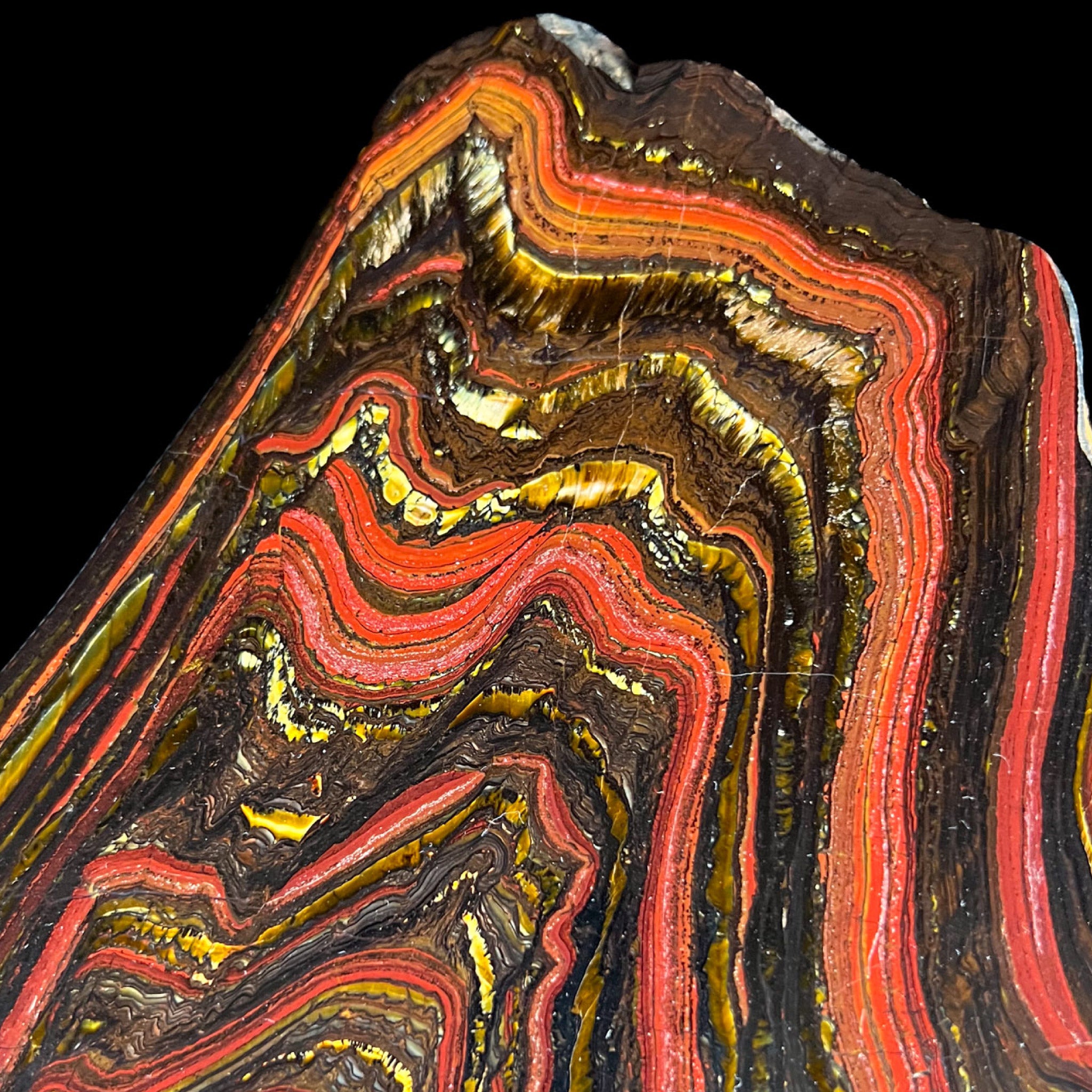 Close up of Tiger Eye, Tiger Iron stone with red, golden, and metallic banding