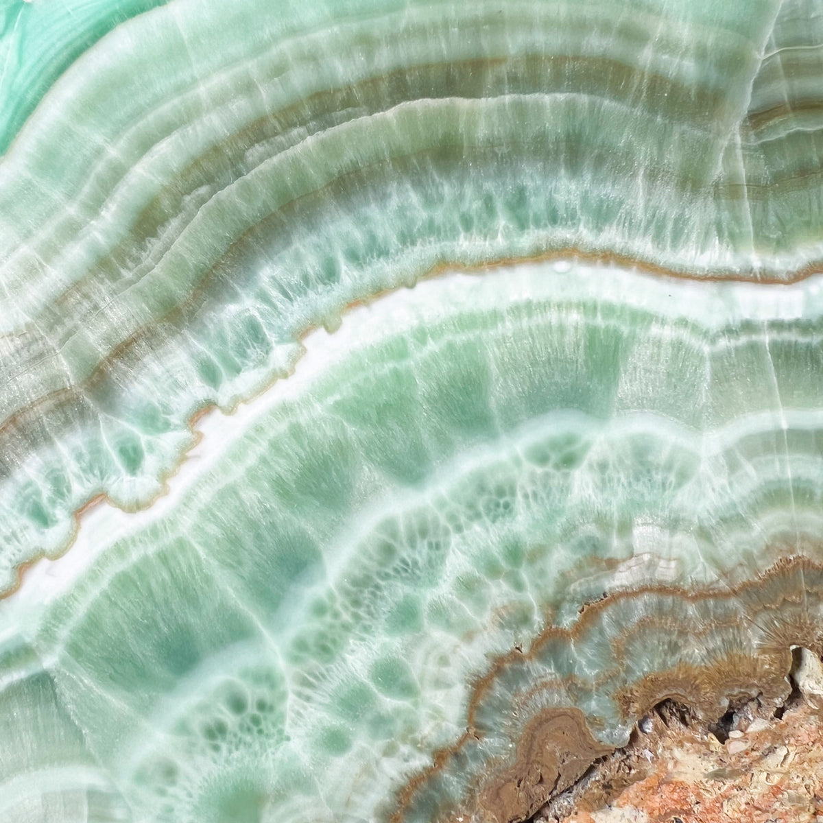 Close Up of Green Aragonite Crystal Banding on Stone Slab