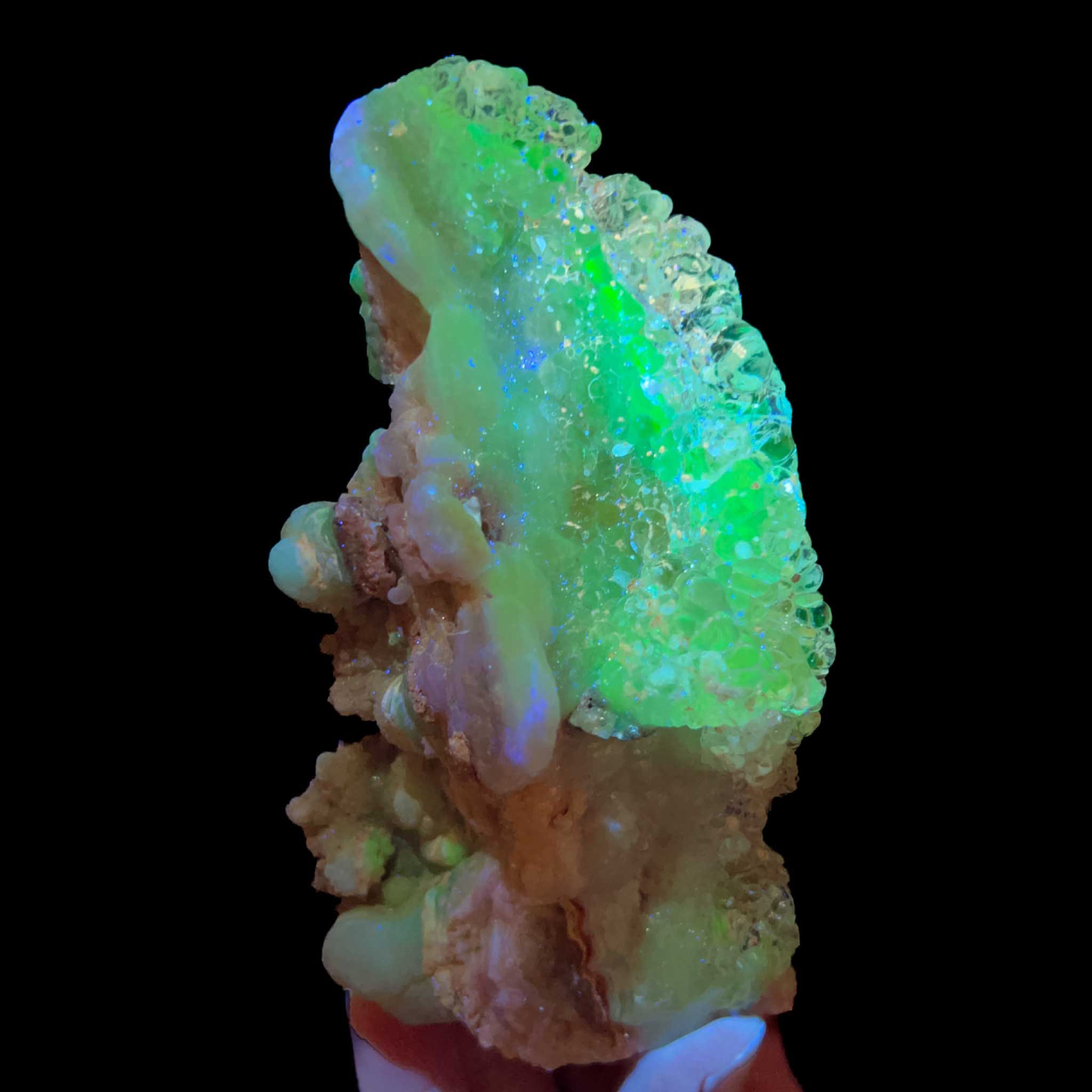 Hyalite Opal crystal specimen displaying green fluorescence under UV light 