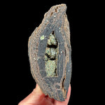 Olivine crystals inside a volcanic bomb rock specimen