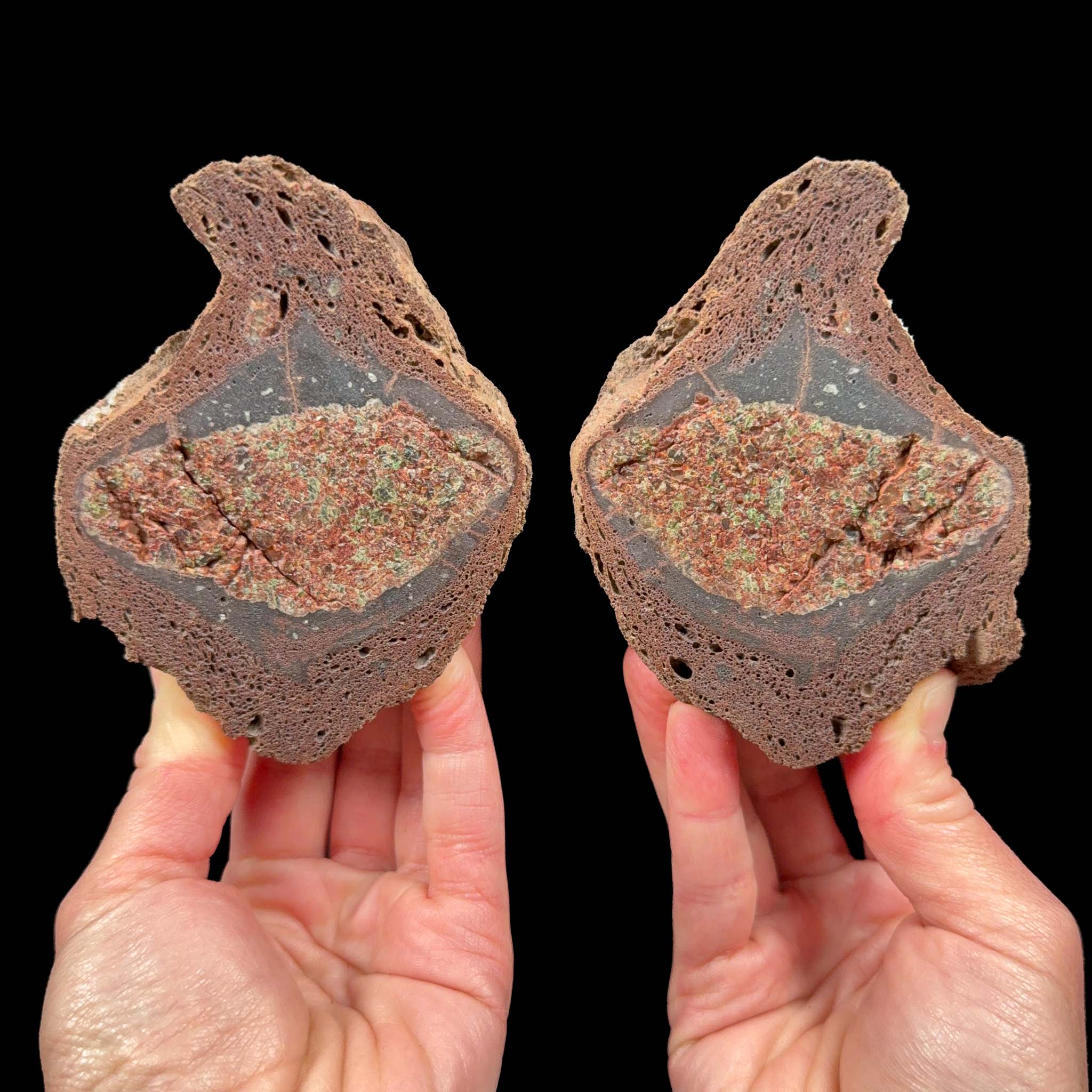 Volcanic Bomb pair with Olivine and Garnet crystals inside