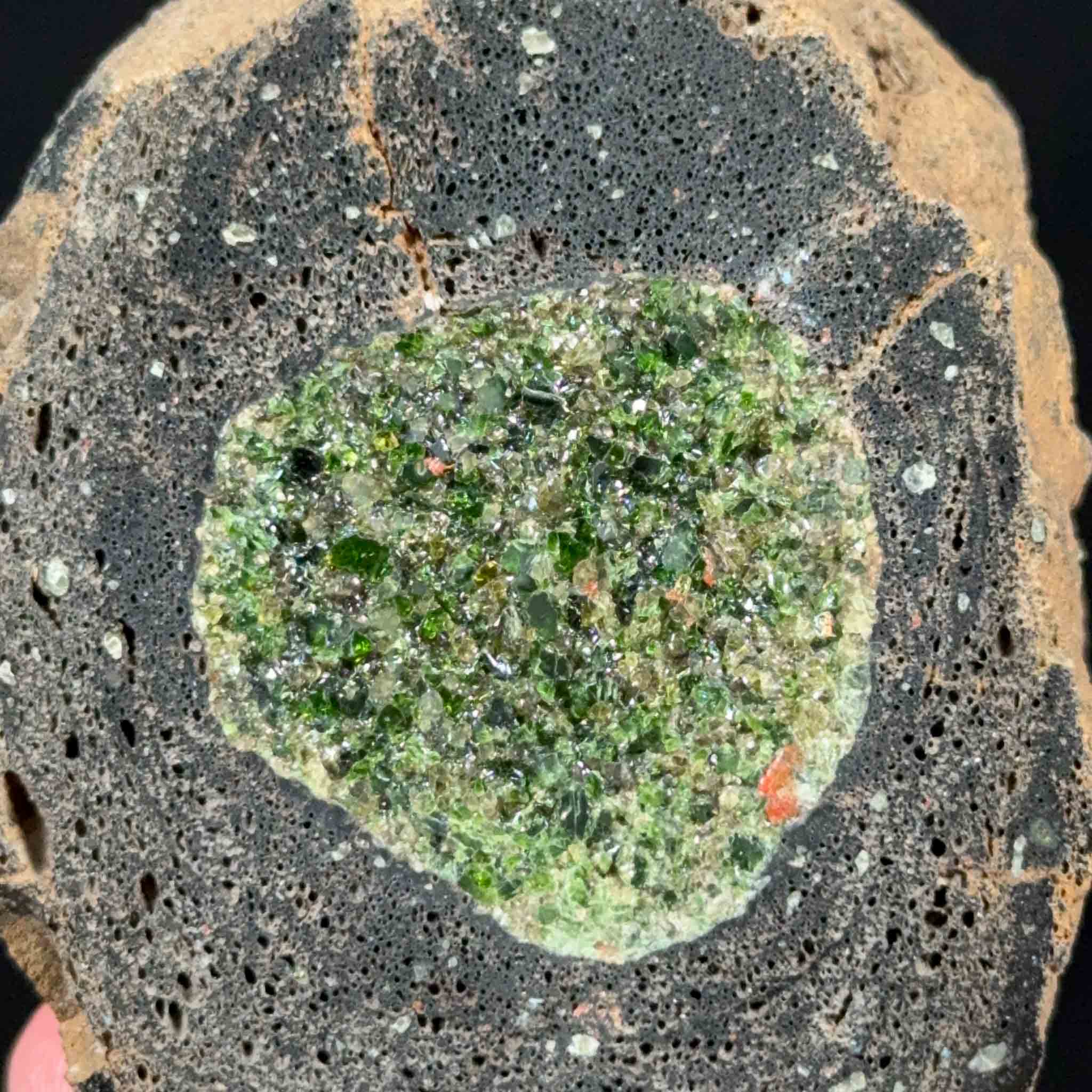 Close up of Olivine and Peridot crystals inside a volcanic bomb