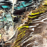 Close up of Chrysocolla and Volborthite inclusions in Petrified Wood from Turkey