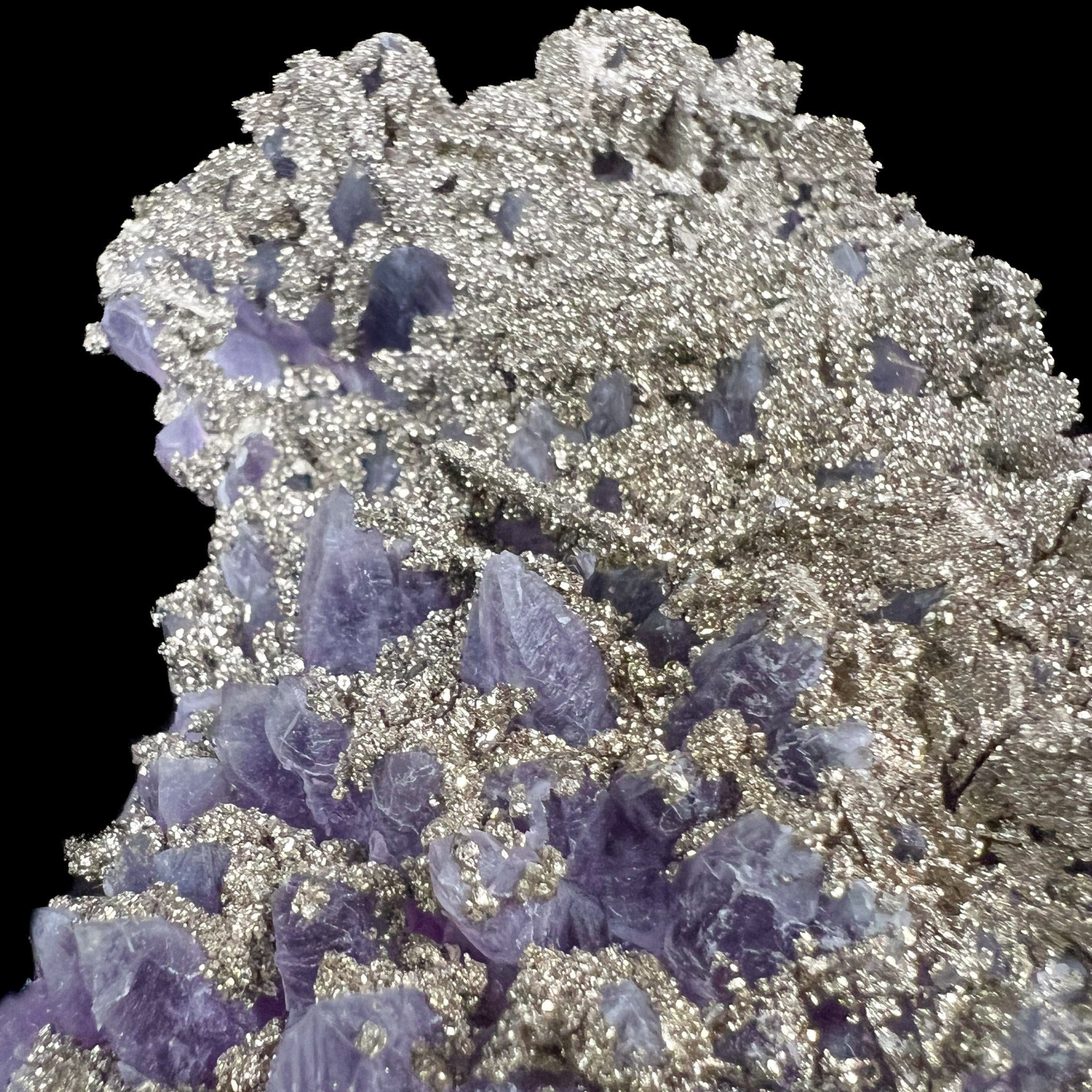 Natural mineralization of Pyrite on top of Amethyst crystals