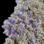 Close Up of Pyrite crystal mineralization on top of Amethyst crystals