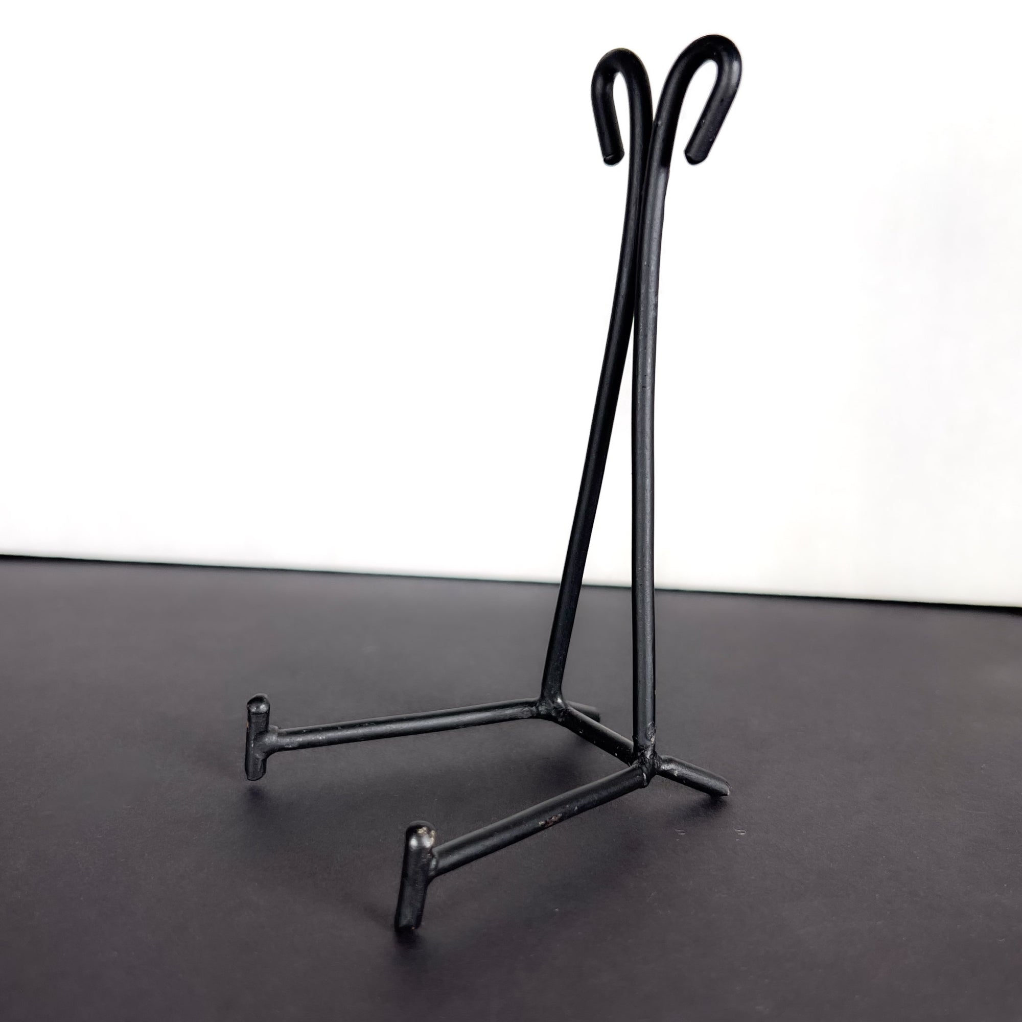 Small Black Metal Display Stand with Scroll Top