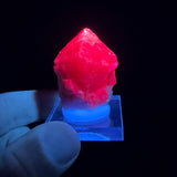 Spinel crystal displaying red fluorescence under UV light
