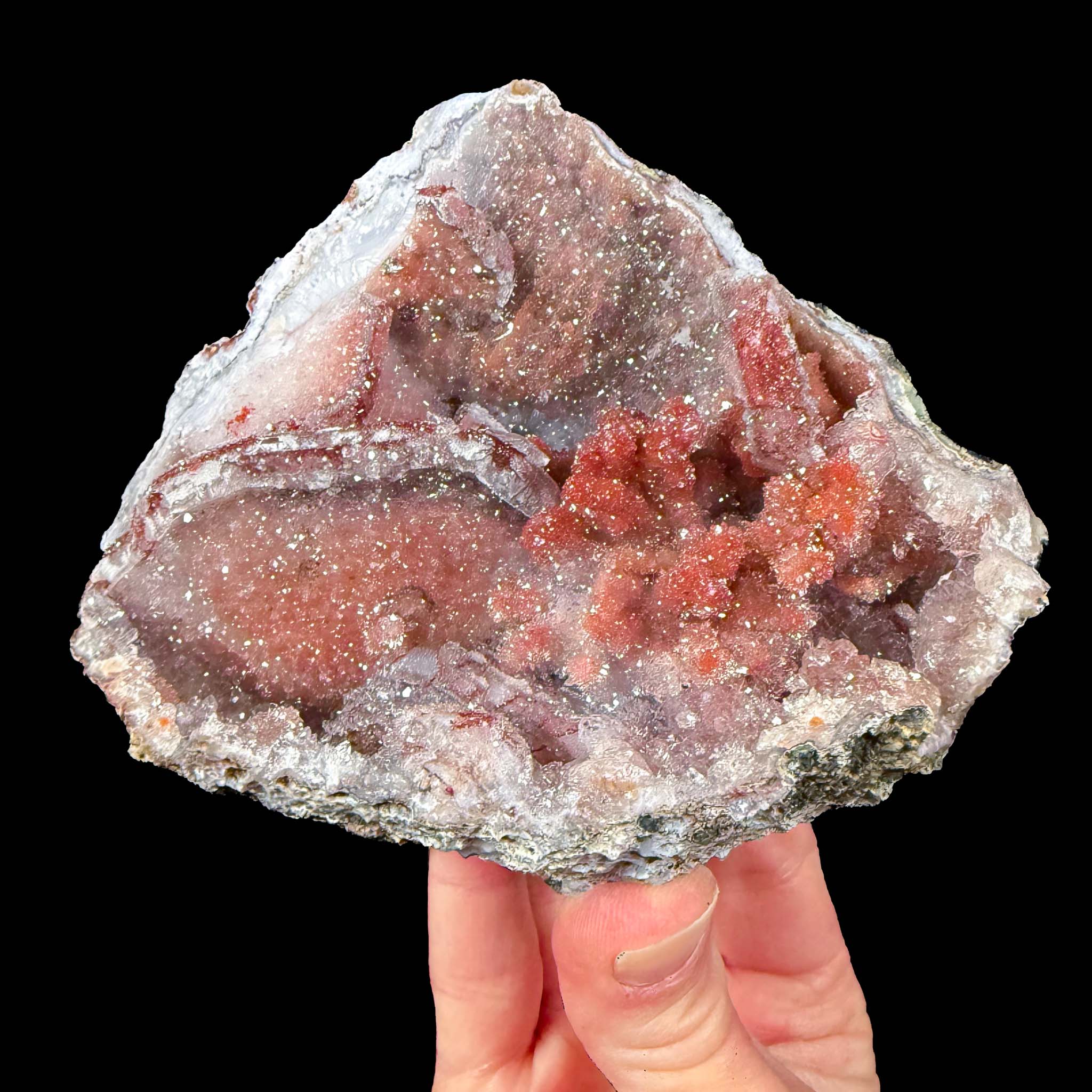 Red quartz crystals inside a geode from Morocco