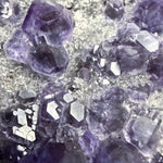 Close up of purple dodecahedral fluorite crystals