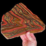 Large Slice of Tiger Iron displaying red, golden, and metallic banding