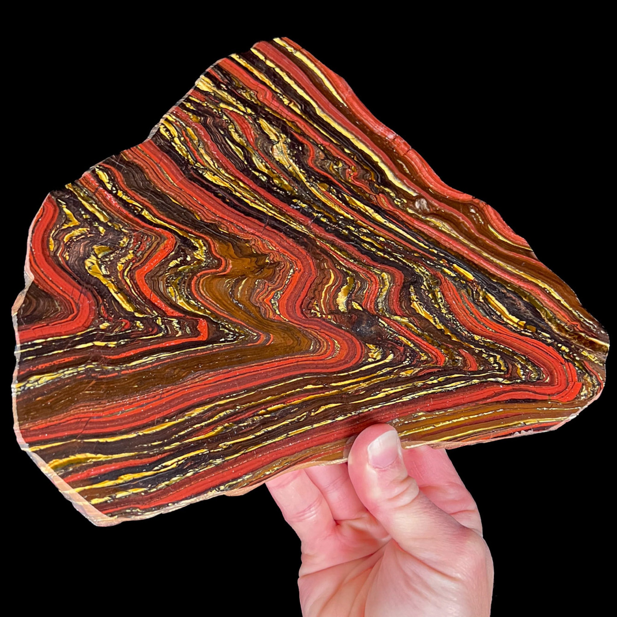 Large Slice of Tiger Iron displaying red, golden, and metallic banding