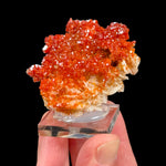 Red orange crystals of Vanadinite on white Barite crystals